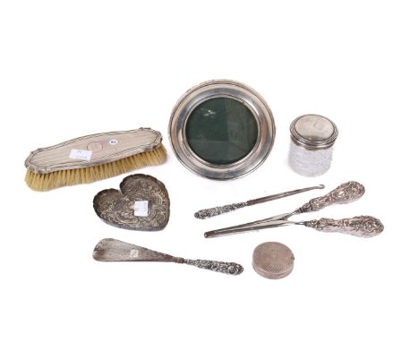 Various silver dressing table requisites. Including a photograph frame, glove stretchers, compact, etc.
