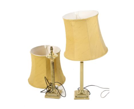 A pair of contemporary brass Corinthian column lamp bases. Having ribbed details and mounted on square bases, with gold shade
