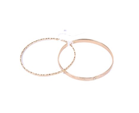 Two 9ct gold bangles. One of scroll form, hallmarked 375, the other with impressed decoration, marked 375. Gross weight 12.5g