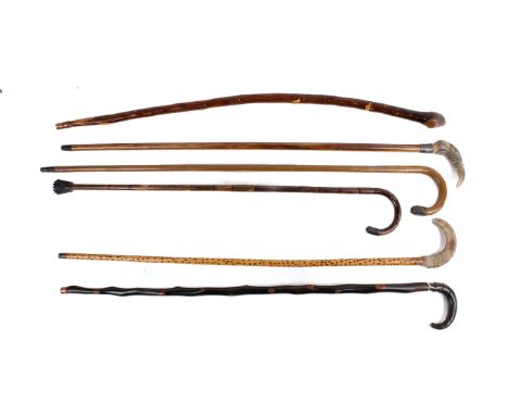 Six vintage walking canes. Of various designs, including two with horn handles and bamboo examples, one having a silver colla