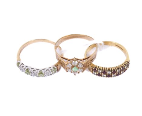 Three stone set gold rings. Comprising an 18ct gold ruby and diamond half eternity ring, size P, and two 9ct gold dress rings