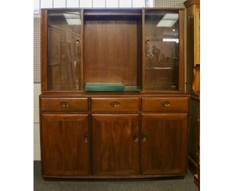 Late 20th century two section Ercol glazed display cabinet sideboard. Illuminated central open shelf section flanked by glaze