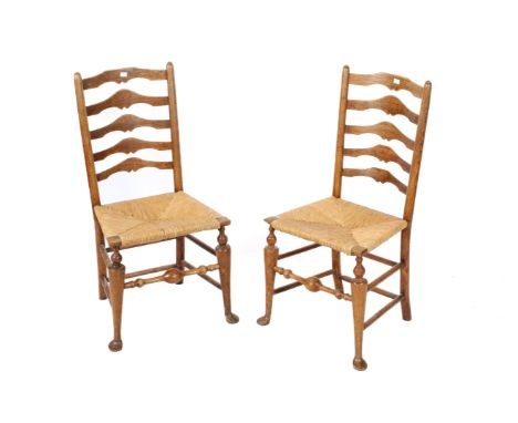 Pair of rush seat ladder back chairs. Turned tapering supports united by stretchers with pad feet. H96cm