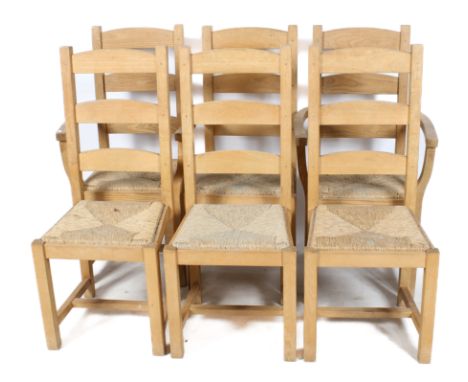 Set of six ladderback rush seat kitchen chairs. Including two carvers, raised on square supports united by stretchers. H107cm
