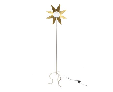 A contemporary standard lamp. Topped with a rounded white bulb in a brass sunburst. Total H189cm.