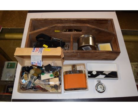 A cutlery tray containing a hip flask, various buttons etc.