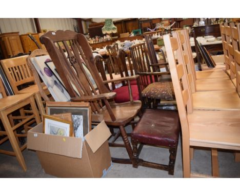 An oak stick and wheel back rocking chair