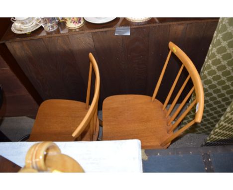 A pair of stick back kitchen chairs 