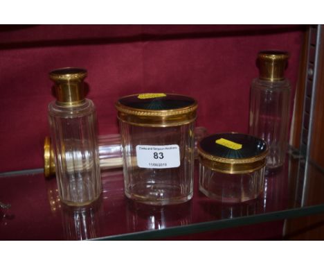 Five green enamel and gilt topped glass jars 