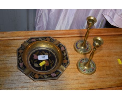 An Eastern brass and enamel decorated ash tray; together with a pair of similar candlesticks