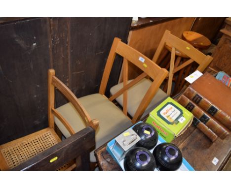 A pair of light oak dining chairs 