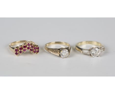 A gold ring, mounted with two rows of circular cut rubies in a V-shaped design, detailed '14K', weight 5.2g, ring size approx