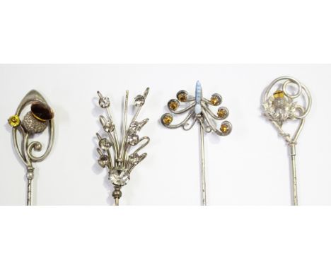 A silver topped and yellow paste hatpin with a thistle motif, Chester 1906 by Charles Horner, a silver topped, pale blue enam
