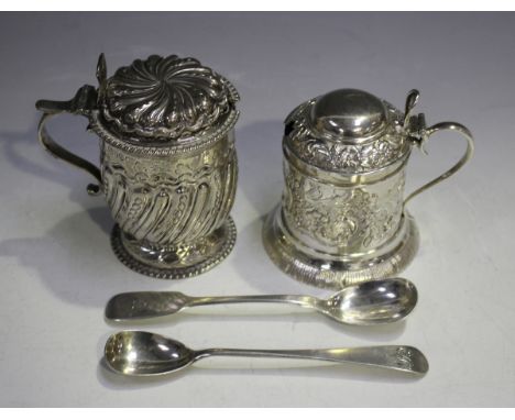 A Victorian silver cylindrical mustard with domed hinged lid, decorated in relief with foliate scrolls and flowers, above sim