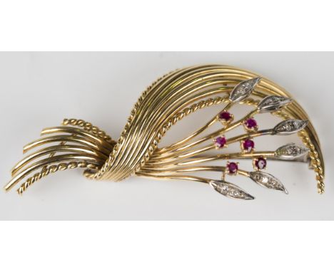 A gold, ruby and diamond brooch, designed as a foliate and scrolling spray, mounted with six circular cut rubies, otherwise s