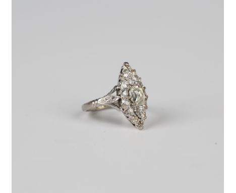 A diamond set marquise shaped cluster ring, claw set with the principal curved rectangular mixed cut diamond at the centre, o