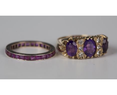 A 9ct gold, amethyst and colourless gem set ring, mounted with three oval cut amethysts and two rows of three colourless gem 