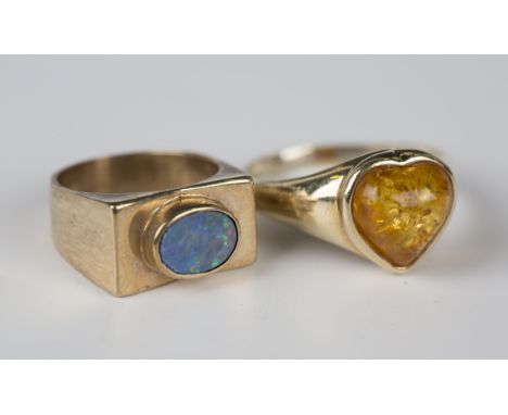 A 9ct gold ring, mounted with an oval opal doublet within a rectangular surround with a textured finish, Birmingham 1972, rin