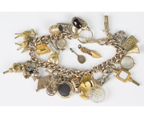 A gold hollow curblink charm bracelet with a heart shaped padlock clasp, mounted with an oval carbuncle garnet, fitted with a