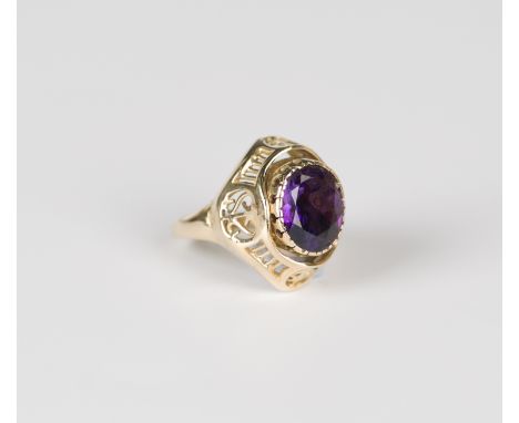 A gold, amethyst and coral ring, the rotating centre mounted with an oval cut amethyst to one side and coral beads to the oth