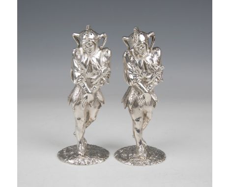 A near pair of rare Victorian silver novelty jester pepper casters, each finely modelled as a standing court jester, the remo