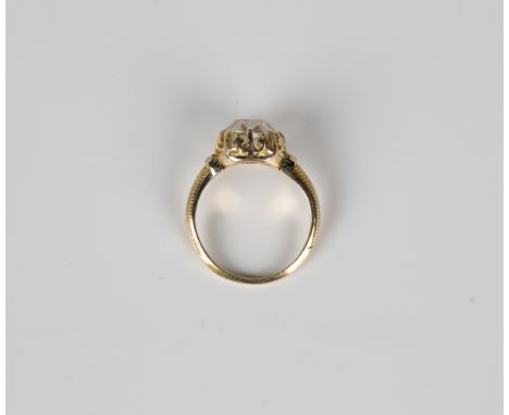 A gold and diamond single stone ring, claw set with a cushion cut diamond, the mount with black enamelled decoration to the s