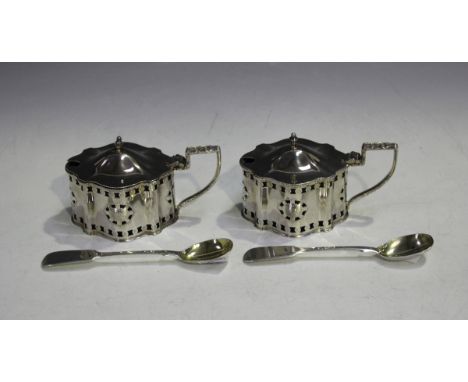 A pair of Elizabeth II silver shaped oval mustards, each with a domed hinged lid and urn shaped finial above pierced medallio