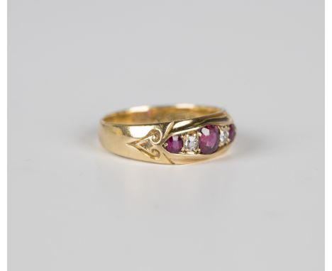 An 18ct gold, ruby and diamond five stone ring, mounted with three cushion cut rubies alternating with two cushion cut diamon