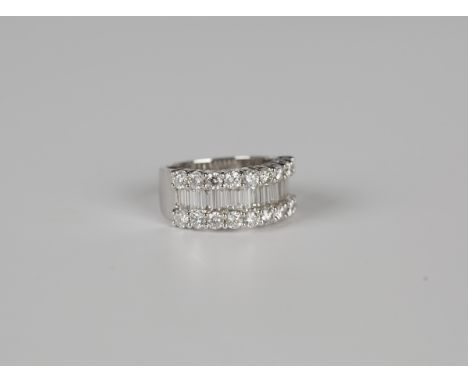 A white gold and diamond half-hoop ring, mounted with a row of baguette diamonds between two rows of nine circular cut diamon