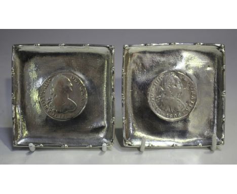 Two silver square dishes, each inset with a coin within a stippled border and faux bamboo rim, total weight 119.5g, width 8.3