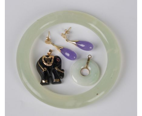 A jade circular bi pendant, a 9ct gold mounted pendant, designed as an elephant, a pair of gold mounted lavender coloured jad