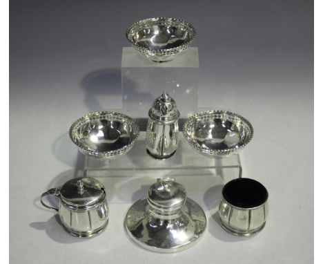 A George V silver three-piece condiment set of circular lobed form, comprising pepper caster, salt and mustard, Birmingham 19