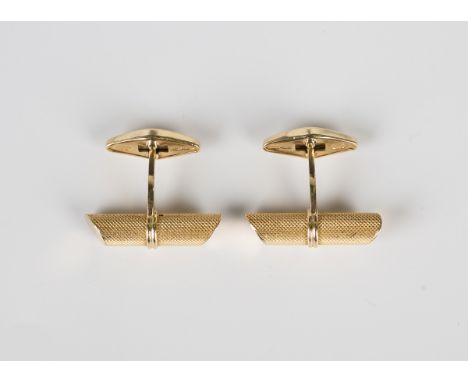 A pair of gold cufflinks, each of tapered cylindrical baton form with engine turned decoration, with folding lozenge shaped f