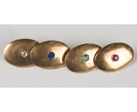 A pair of gold, ruby, emerald, sapphire and diamond cufflinks of curved oval design, detailed '15ct', weight 7.6g, dimensions