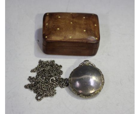 A William IV silver vinaigrette of circular form with cast floral decorated rim, the engine turned hinged lid revealing a gil