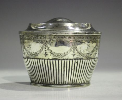 A Victorian silver tea caddy of half-reeded oval form, engraved with a band of foliate pendant garlands, London 1882 by John 