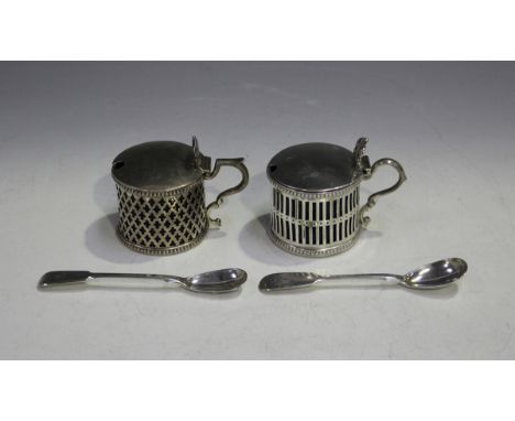 Two Victorian silver cylindrical mustards, each with a slightly domed hinged lid and pierced thumbpiece above pierced sides b