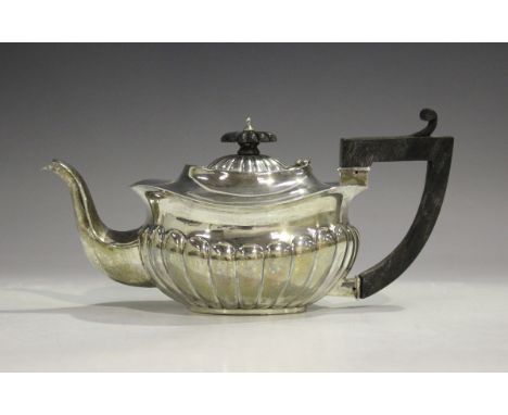 A late Victorian silver and oval half-reeded bachelor's teapot with undulating rim, Birmingham 1899 by Eustace George Parker,