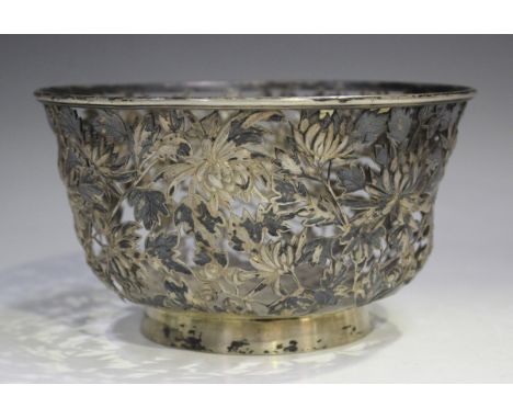 A Chinese silver circular bowl, the sides pierced and embossed with chrysanthemums, on a circular foot, maker's mark 'KC' to 
