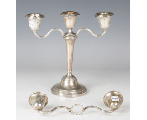 An Elizabeth II silver candlestick with detachable screw urn shaped sconce and a matching detachable twin scroll branch to fo