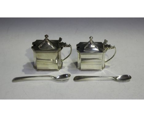 A near pair of silver mustards, each of rectangular form with everted corners and reeded rims with a domed hinged lid, knop f