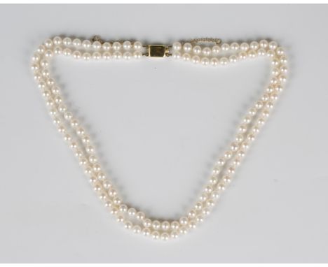 A two row necklace of uniform cultured pearls on a gold rectangular clasp, detailed '375', fitted with a safety chain, length
