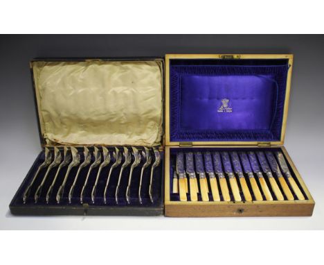 A set of twelve 19th century plated and ivory handled fruit knives and forks with engraved decoration, cased, a set of twelve
