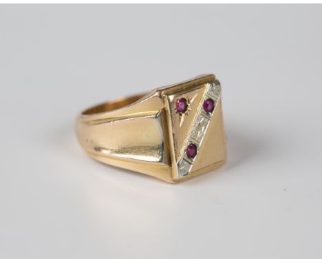 A gold and synthetic ruby rectangular signet style ring with dished shaped shoulders, detailed '750', weight 14.7g, ring size