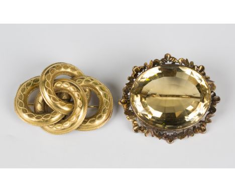 A Victorian gilt metal brooch in an entwined loop design with bead and wirework decoration, width 5cm, and a gold mounted ova