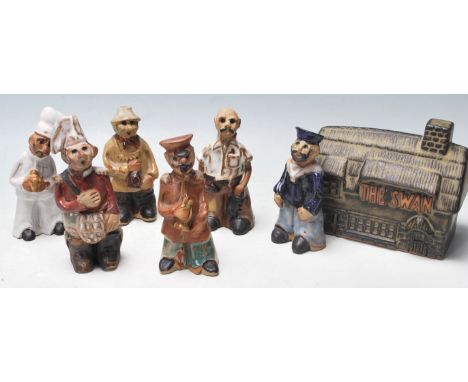 A collection of retro vintage 1960s Cornish Tremar pottery figurine in various costumes all with semi glazed two tone decorat