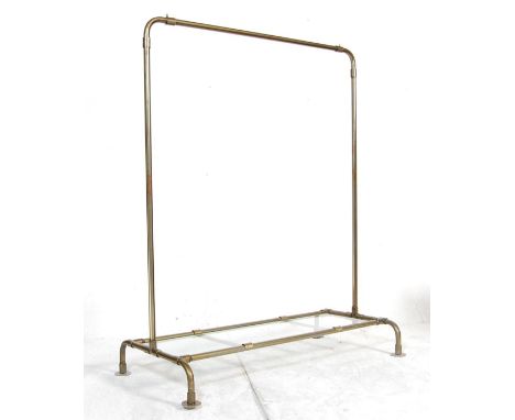 A stunning vintage industrial metal haberdashery shop floor standing clothes rail having arched top, glass base / shoes shelf