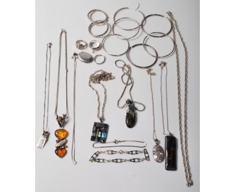 A collection of mixed ladies jewellery to include large hoop earrings, silver rings, a silver locket, a pendant necklace set 