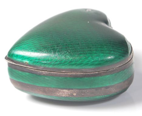 An early 20th Century silver and green guilloche enamelled trinket box in the shape of a heart. The box being set with a diam