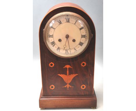 A Marti &amp; Co mahogany inlaid mantel clock. Of tall arched form, the case with harebell and flower roundel inlaid detailin